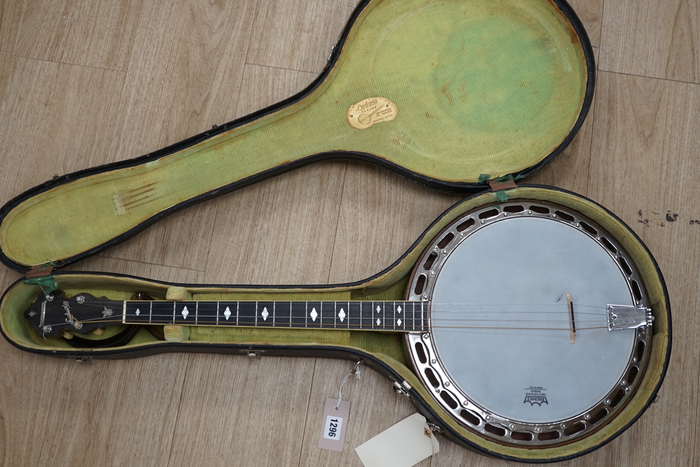 A cased 1920s Ludwig 'Kingston', USA tenor four string banjo, inlaid back, mother of pearl inlay to the fretboard, modern Remo skin, length of body 34cm, overall length 87cm, in a fitted hard case